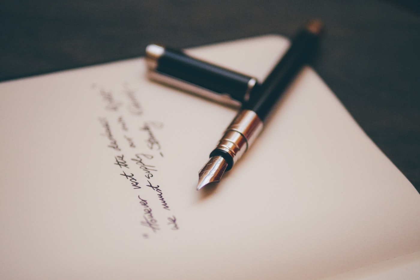 Fountain pen resting on handwritten letter